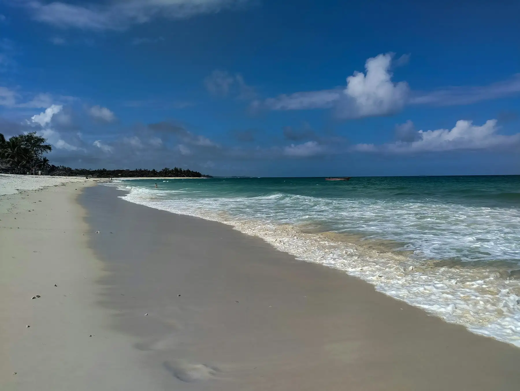 White sand and turquoise Indian Ocean water along the Kenyan coast at Diani.